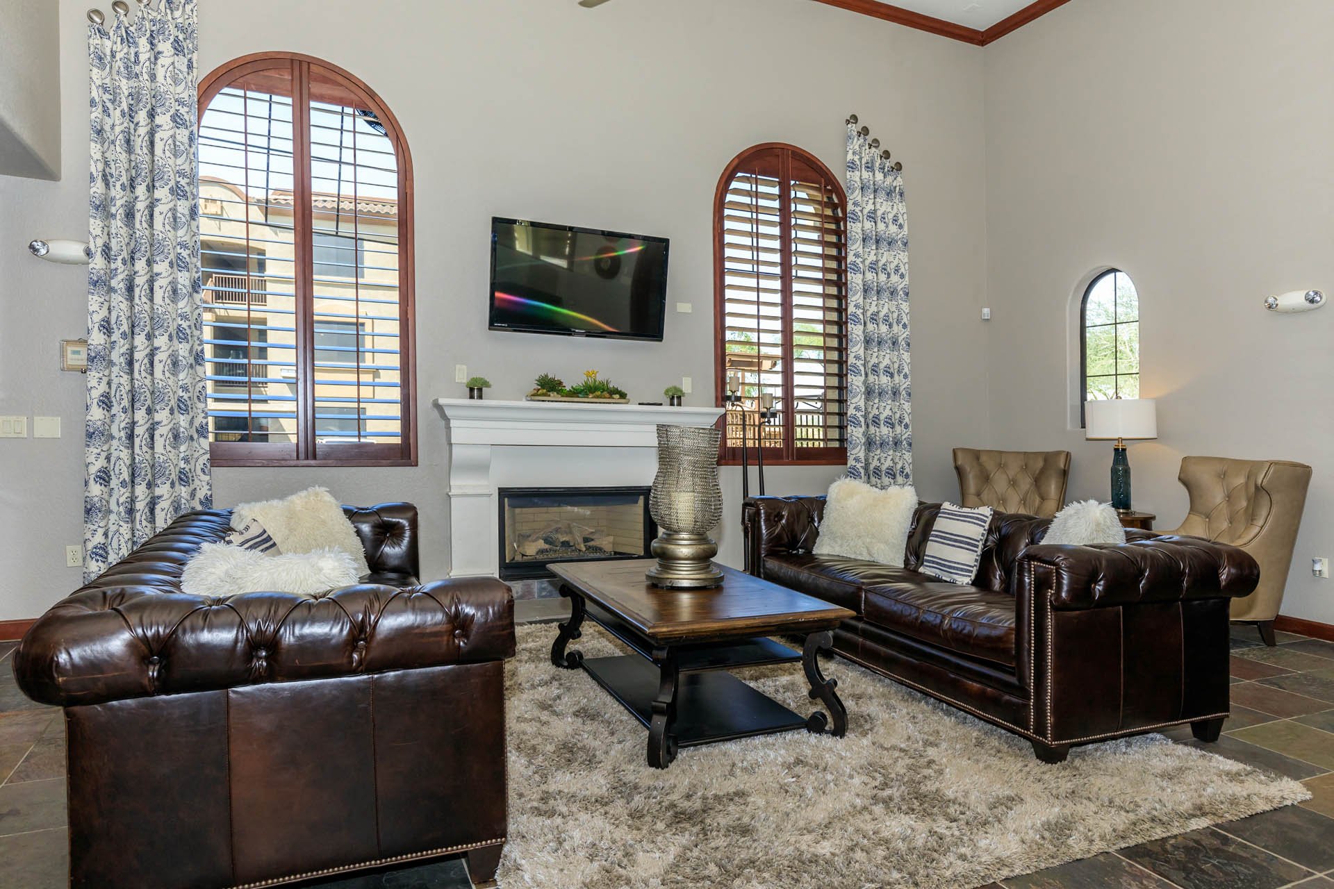 a living room with leather couches and a television